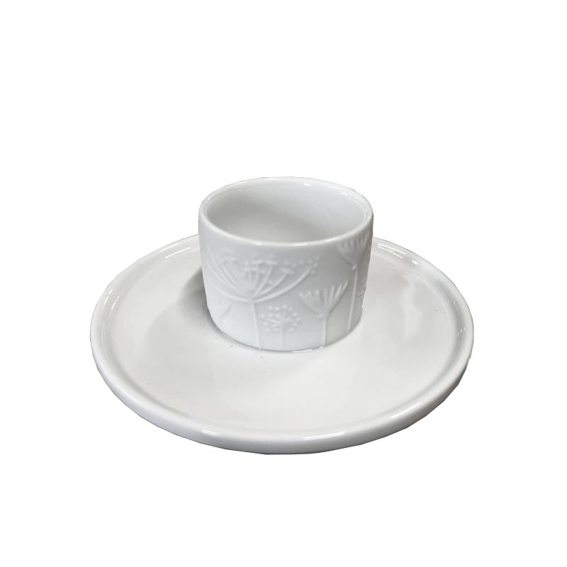 Porcelain floral egg cup and saucer by Rader