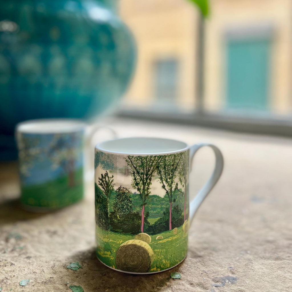 A Year in Normandie Mug by David Hockney (Purple Tree and Hay Bales)
