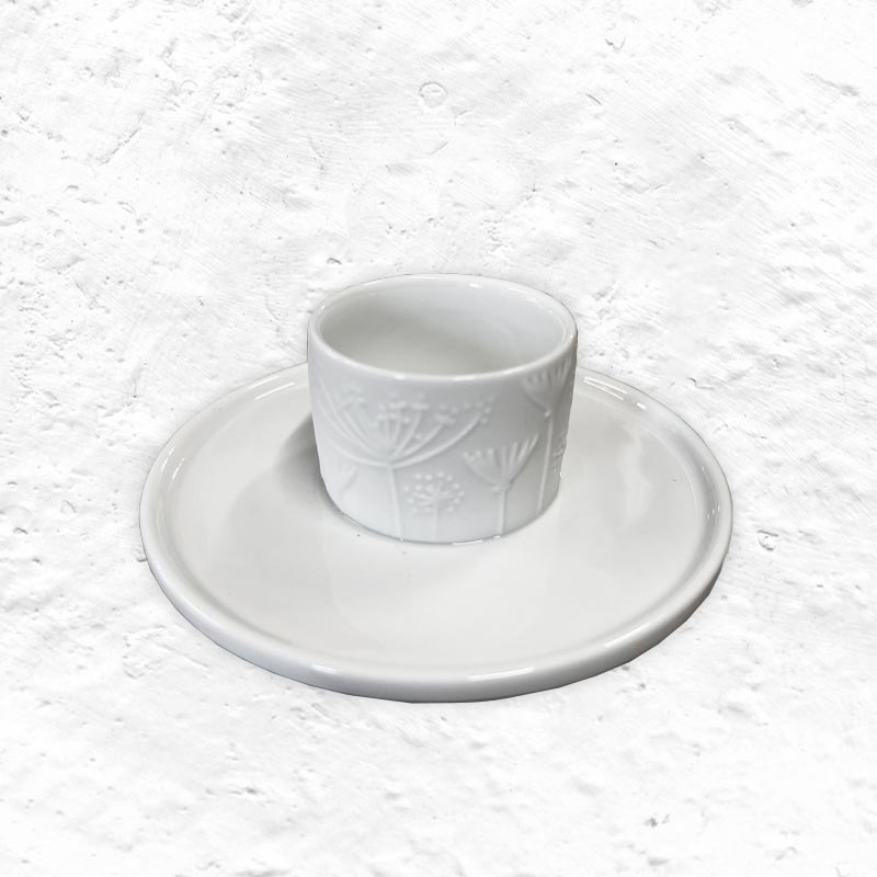 Porcelain floral egg cup and saucer by Rader
