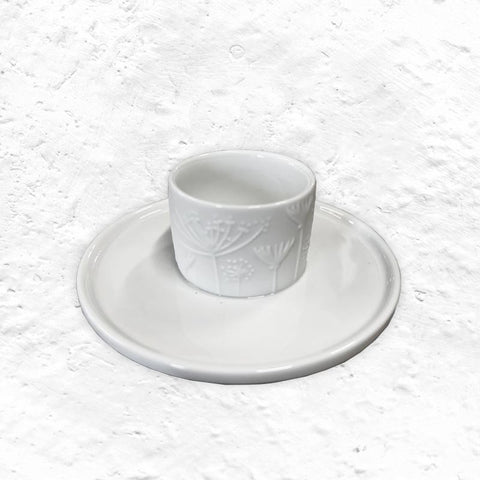 Porcelain floral egg cup and saucer by Rader